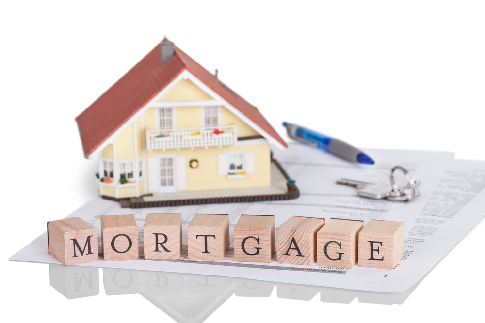 Animated house with wooden blocks spelling the word mortgage